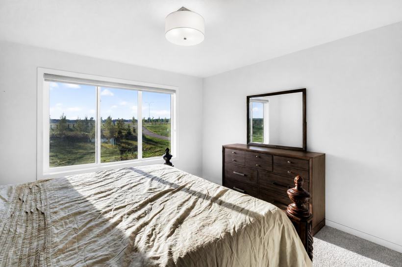 Primary window, looking west over green space and a pathway, 215 Mallard Grove SE